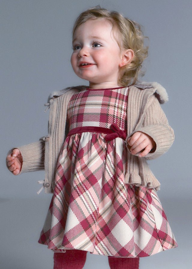 Raspberry plaid dress with gathered waist and burgundy bow.

