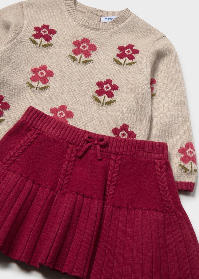 Raspberry knit skirt and floral knit sweater set for baby girl.

