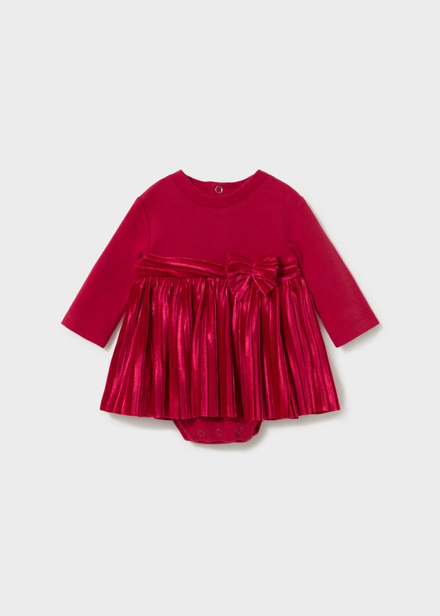 Red baby romper with pleated skirt detail and bow, Style 16‑02813‑019.