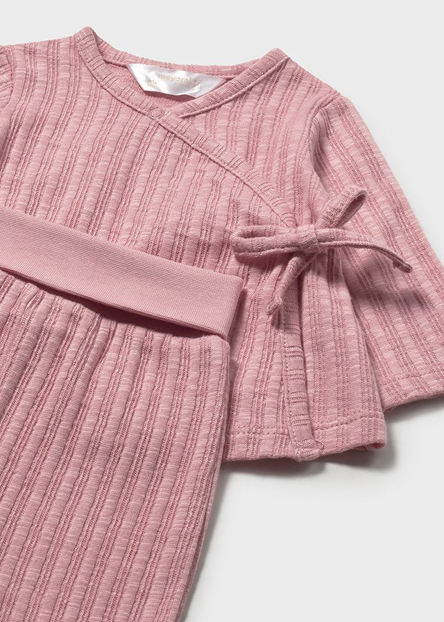 Baby girl pink ribbed wrap top with matching footed pants.