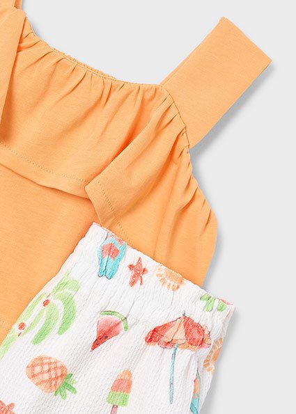 Two-piece girls’ summer outfit with orange ruffled top and white printed shorts featuring playful summer icons.