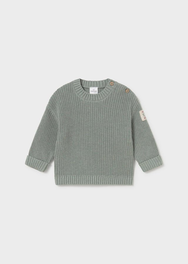 A light sage green ribbed knit sweater for toddlers, featuring a crew neck, long sleeves, and decorative buttons on the shoulders, displayed against a neutral light gray background.