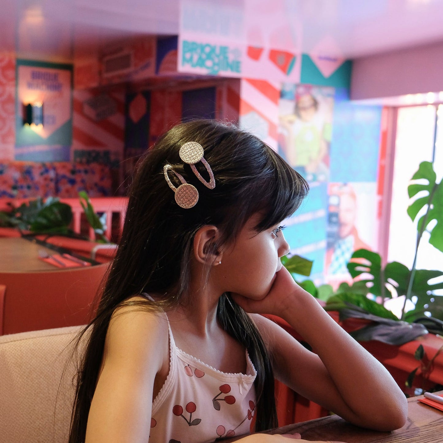 Rockahula disco ball snap clips with disco ball detail in silver glitter in a young girls hair.