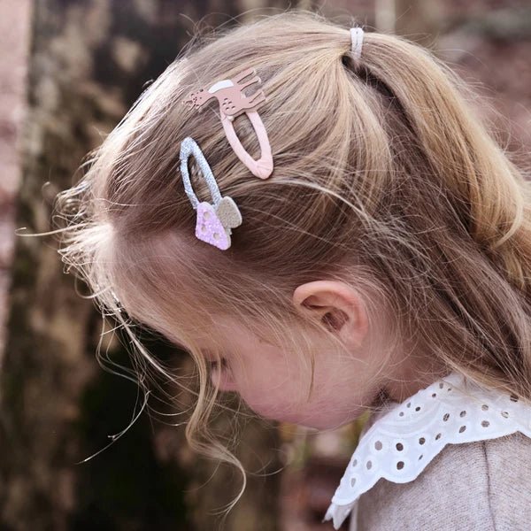 Child with Rockahula Kids forest deer clip set decorative hair clips in a natural setting