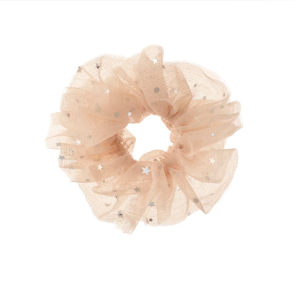 A ruffled tulle hair scrunchie in a soft champagne beige color, decorated with small silver glitter stars, shown on a plain white background.