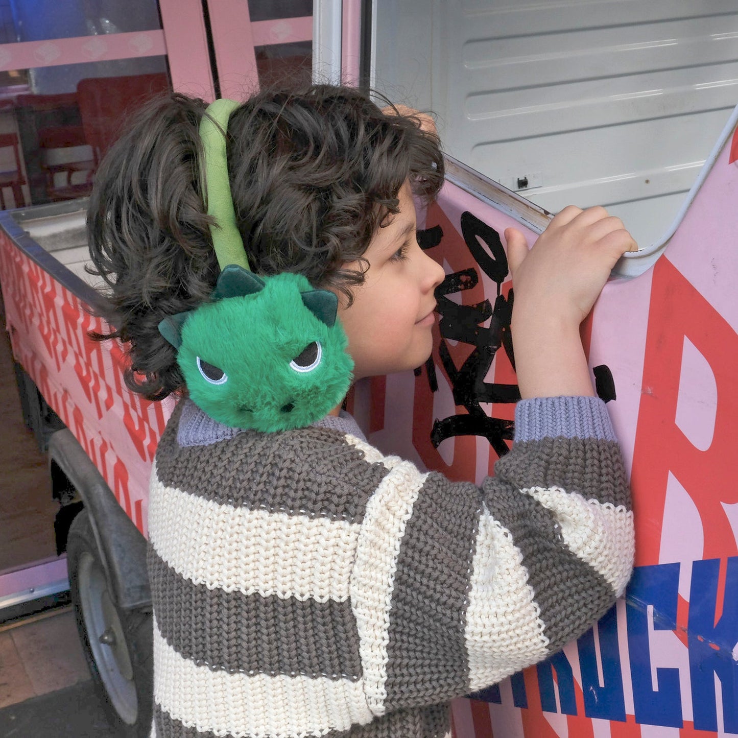 Rockahula t-rex earmuff, green with dino face ears with soft plush spikes